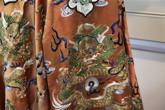 A Chinese apricot satin embroidered silk and metal thread dragon robe, late 19th century,